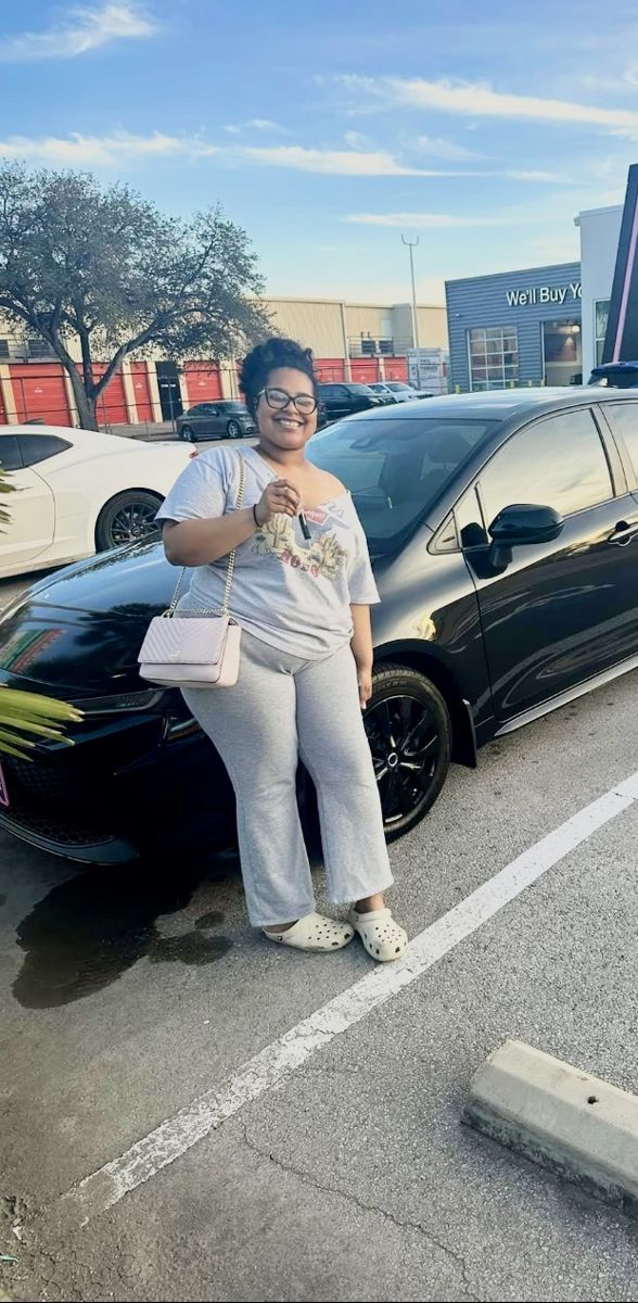 Customer with her black Toyota Corolla
