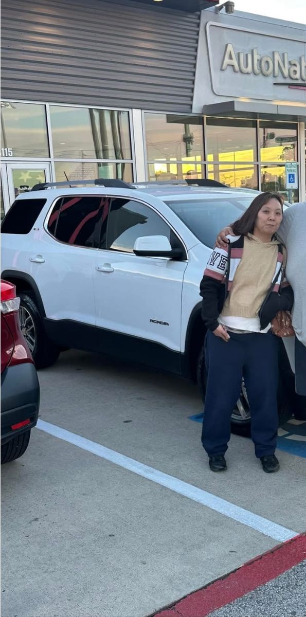 Customer with her white SUV at the dealership